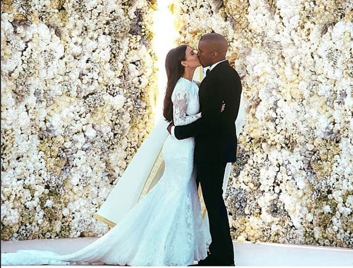 Kim Kardashian nee West walks down the aisle holding hands with her new husband, Kanye West, at Fort Belvedere as smiling guests look on. Pic Courtesy: Instagram 