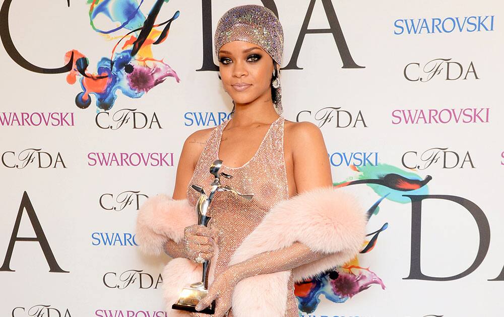 Rihanna holds the Fashion Icon Award at the 2014 CFDA Fashion Awards, in New York. 