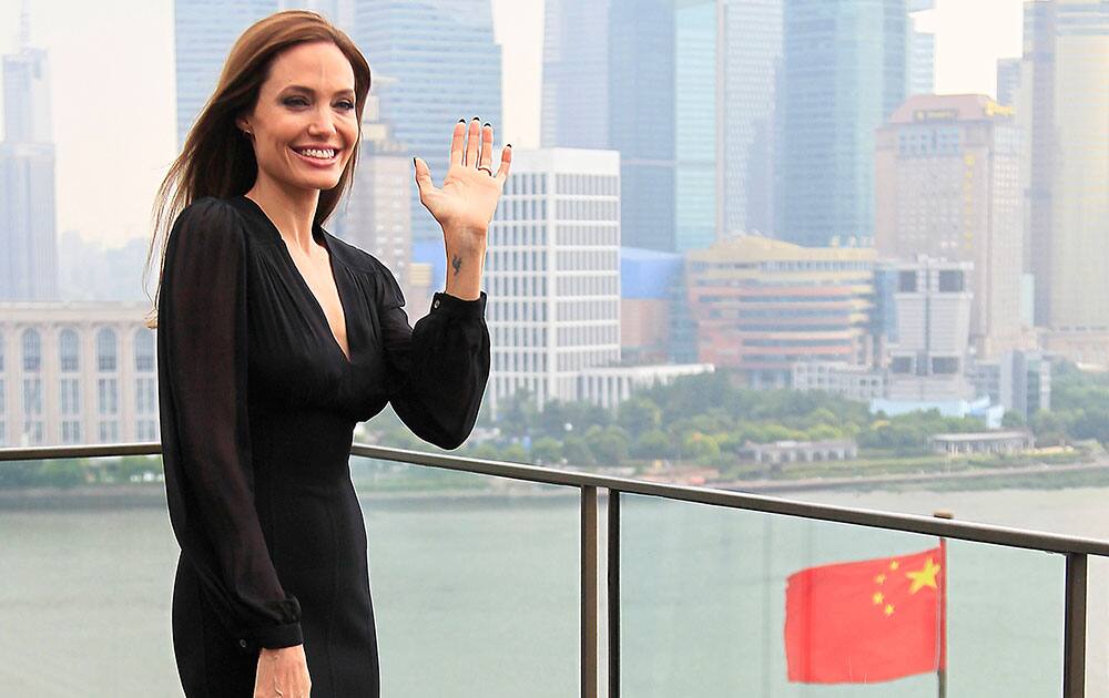 Actress Angelina Jolie waves during a promotion tour for her movie `Maleficent` in Shanghai, China.