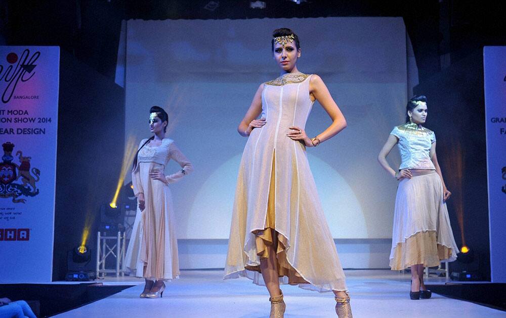 Models walk the ramp to showcase a creation by a student during the Fashionova Graduation Show 2014 organised by National Institute of Fashion Technology in Bengaluru.