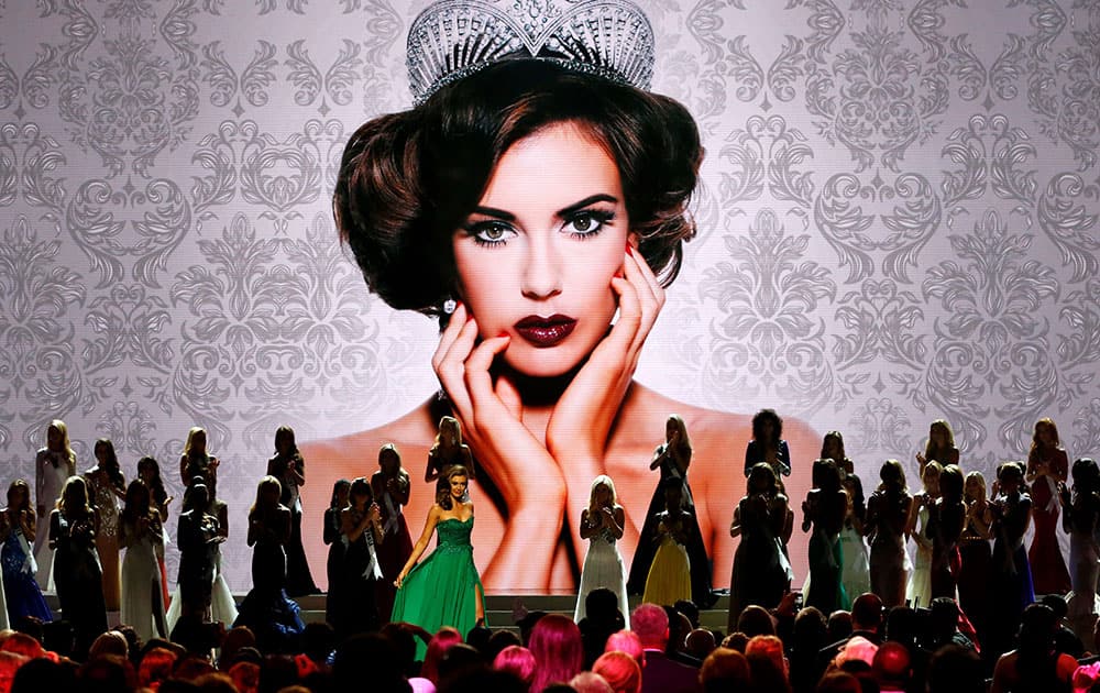 Miss USA 2013 Erin Brady, center left, comes forward during the Miss USA pageant in Baton Rouge, La.