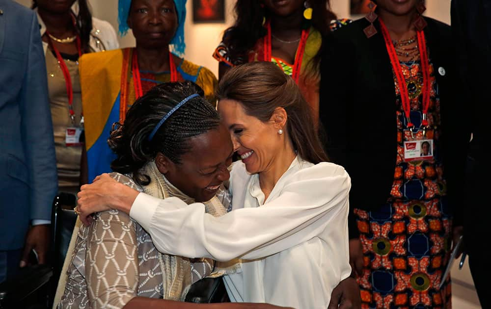 US actress Angelina Jolie, right, Special Envoy of the United Nations High Commissioner for Refugees, hugs Neema Namadamu of the Democratic Republic of Congo at the 'End Sexual Violence in Conflict' summit in London.