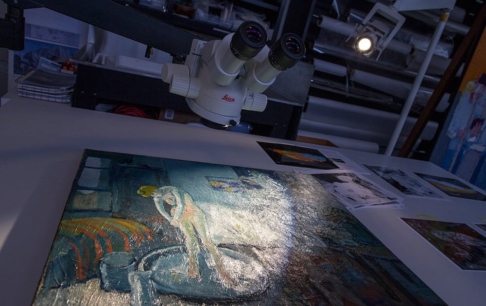 'The Blue Room,' one of Pablo Picasso's first masterpieces sits under a microscope at The Phillips Collection, in Washington. Scientists and art experts have found a hidden painting beneath the painting.