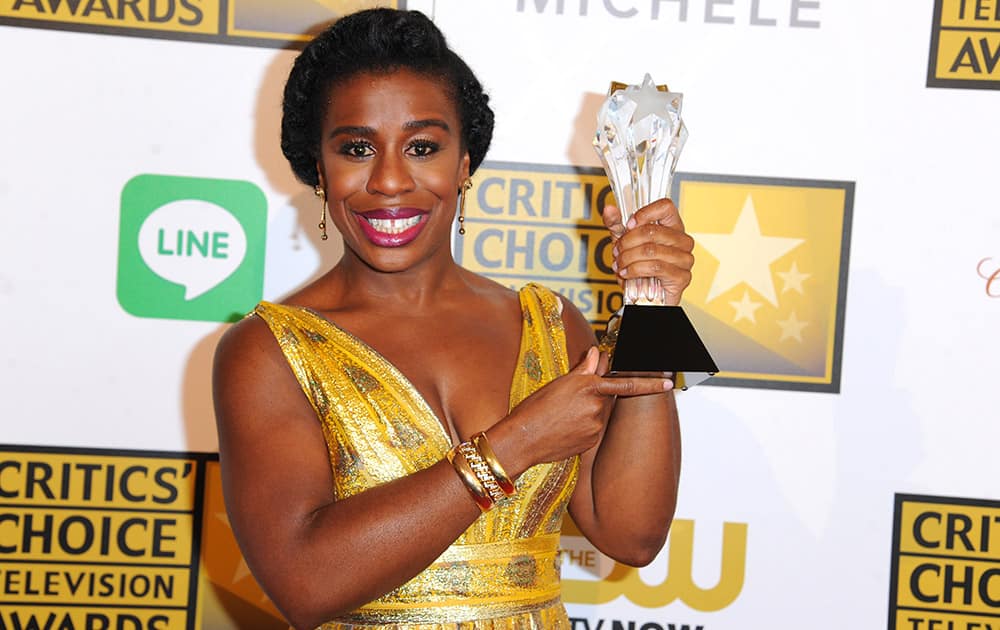 Uzo Aduba poses with the award for best guest performer in a comedy series for 'Orange Is the New Black,' in the press room at the Critics' Choice Television Awards at the Beverly Hilton Hotel.