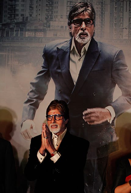 Bollywood's biggest star, Amitabh Bachchan gestures to the audience as he stands in front of a poster of his upcoming television fiction series 'Yudh' during its promotion in New Delhi.