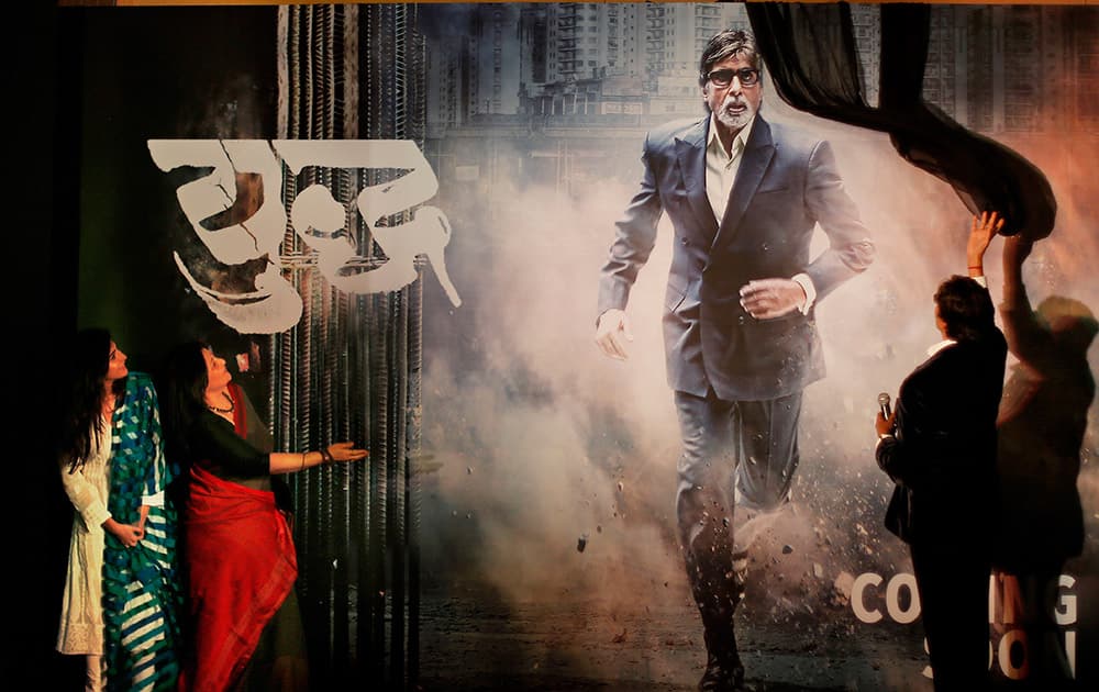 Amitabh Bachchan, unveils the poster of his upcoming television fiction series 'Yudh' as co-actors, Aahana Kumra and Sarika, watch during its promotion in New Delhi.