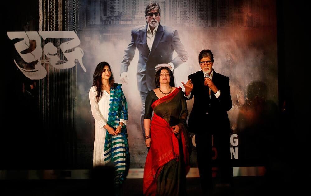 Bollywood's biggest star, Amitabh Bachchan, speaks as he stands before a poster of his upcoming television fiction series 'Yudh' with co-actors, Aahana Kumra and Sarika, during its promotion in New Delhi.