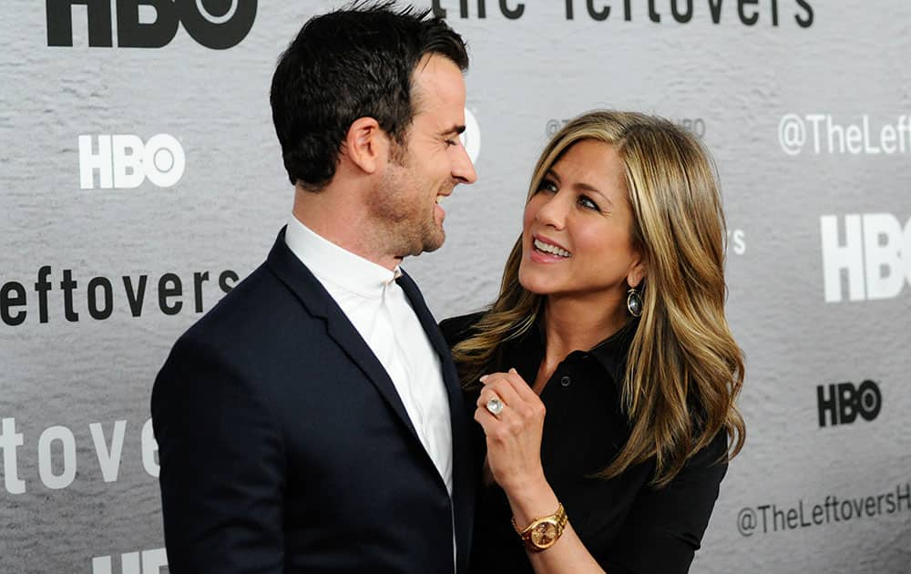 Actors Justin Theroux, left, and Jennifer Aniston attend HBO's `The Leftovers` season premiere at the NYU Skirball Center in New York.