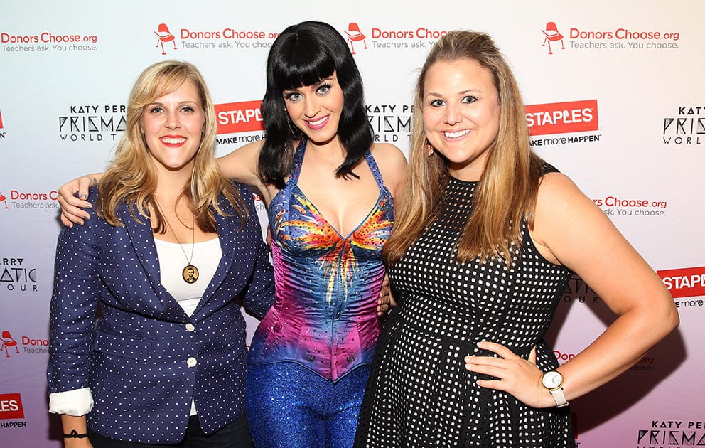 Global pop star Katy Perry with local teachers Julie Rukavina and Michelle Lee, backstage at the Verizon Center during her Prismatic World Tour performance, in Washington.