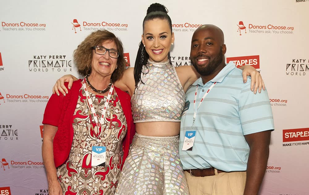 Global pop star Katy Perry with local teachers Pauline Weisz, left, and Matthew Hall, right, backstage at the Philips Arena during her Prismatic World Tour performance in Atlanta, GA.