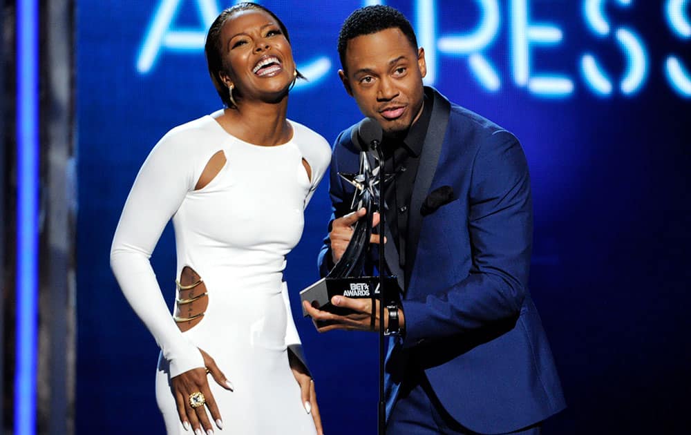 Eva Marcille, left, and Terrence J present the award for best actress at the BET Awards at the Nokia Theatre.