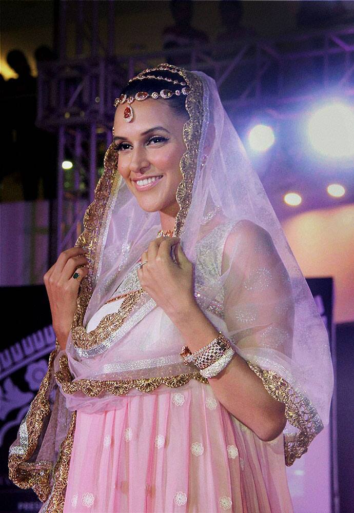 Bollywood actress Neha Dhupia walks the ramp at a fashion event in Thane, Mumbai.