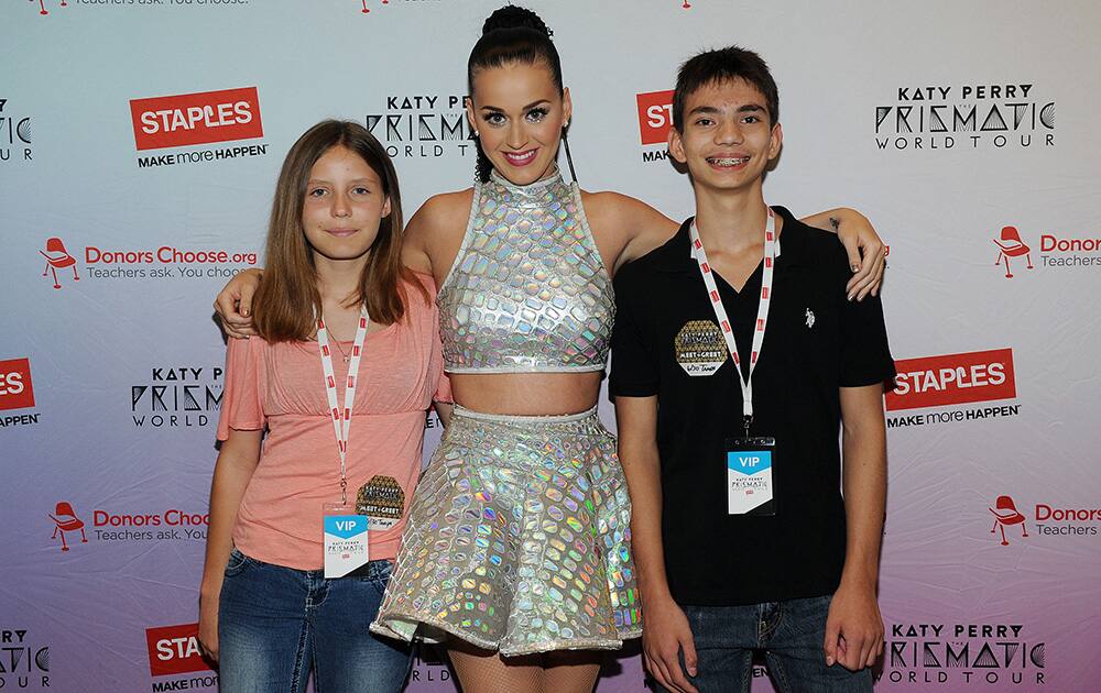 Global pop star Katy Perry with local students, Adalis Moody and Kye Harris backstage at the Tampa Bay Times Forum during her Prismatic World Tour performance.