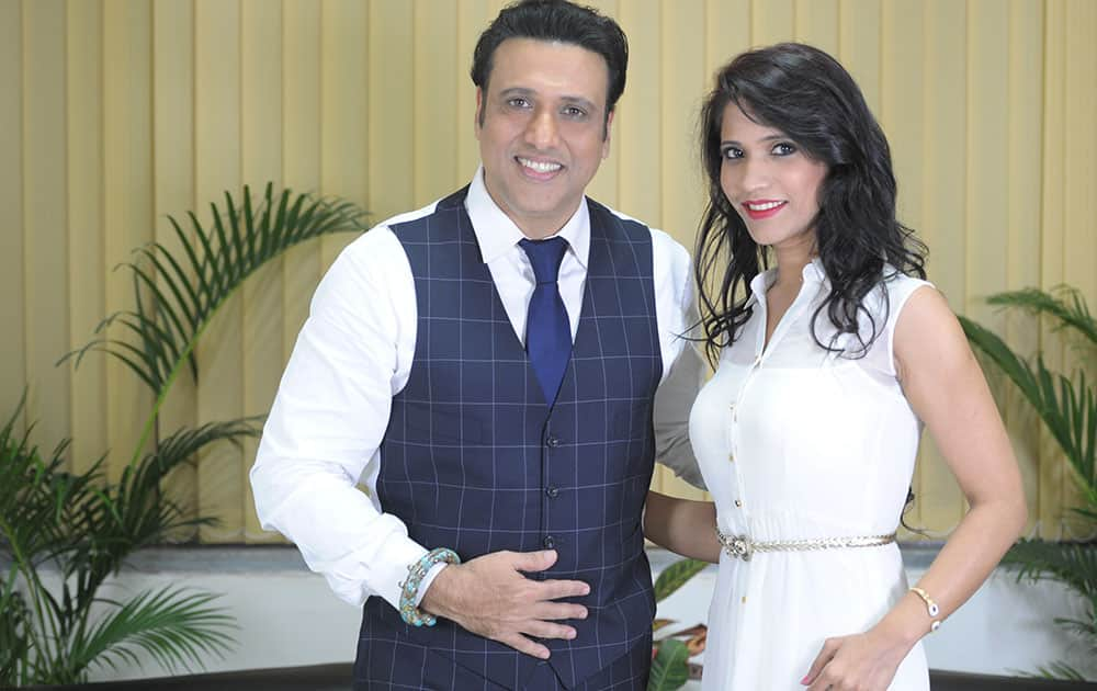 (L-R) Govinda with Richa Sharma during promotional event of a film 'Abhinay Chakra' produced by his home production at Seasons Mall in Pune. dna