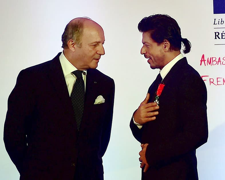 Bollywood superstar Shah Rukh Khan being conferred with Chevalier de la Legion d'Honneur, the highest honour in France by Laurent Fabius, Minister for   Foreign Affairs and International Development of France in Mumbai.