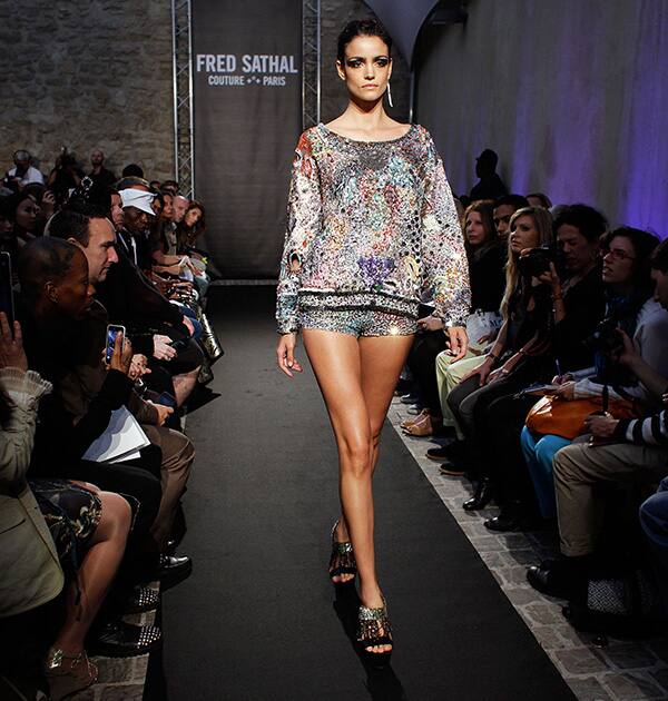 A model wears a creation by French designer Fred Sathal, as part of her Fall Winter 2014-15 Haute Couture fashion collection.