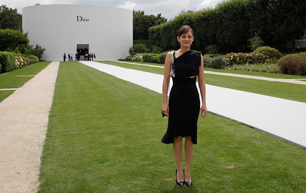 French actress Marion Cotillard poses for photographers as she attends Dior's Fall-Winter 2014-2015 Haute Couture fashion collection, in Paris.