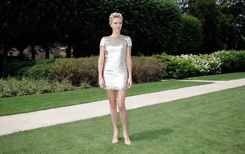 Actress Charlize Theron poses for photographers as she attends Dior's Fall-Winter 2014-2015 Haute Couture fashion collection, in Paris.