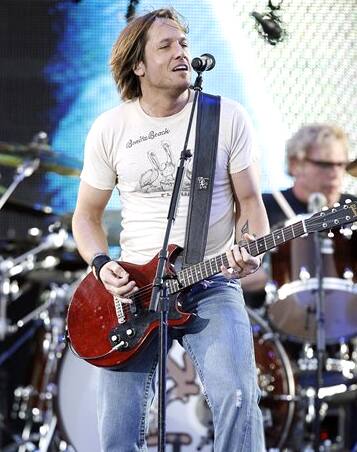 Keith Urban performs during Kenny Chesney's Pirates and Poets tour stop at Lincoln Financial Field in Philadelphia.