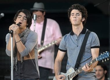 Musicians Joe Jonas, left, and Kevin Jonas of the music group The Jonas Brothers perform in Bryant Park for ABC's 'Good Morning America' show.