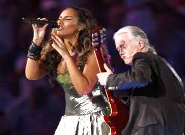 Jimmy Page and Leona Lewis perform at closing ceremony of Beijing 2008 Olympic Games.