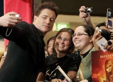 Click Click: Brendan Fraser takes a picture of himself with fans before the premiere of his latest film.