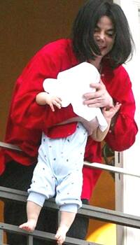 Michael Jackson precariously dangles his son from a window prompting worldwide outrage