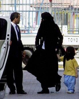 What's that: Michael Jackson wears an abaya, the traditional Arabic women's veil and gown. He walks with his youngest son, Prince Michael II.