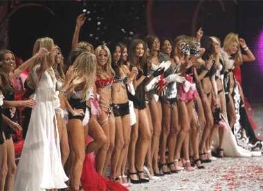 Victoria's Secret models wave at the end of the Victoria's Secret Fashion Show.