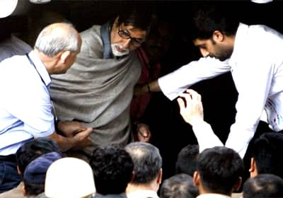 Fans assemble outside Lilavati Hospital as their favourite star Amitabh Bachchan is helped out of the ambulance by his son. 