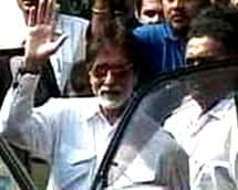 Good times: 'Shenshah' Amitabh Bachchan waves at fans as he is discharged from Lilavati.