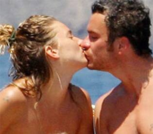 Actress Sienna Miller and boyfriend Balthazar Getty sealed it with a kiss on a vacation.