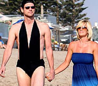 Bikiniman! Jim Carrey and girlfriend Jenny McCarthy hit the Malibu beach for a stroll.