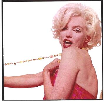 Marilyn Monroe strikes an erotic pose in one of her famous pictures.