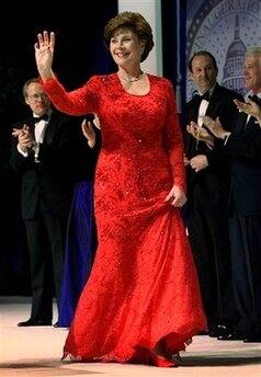 First lady Laura Bush waves as she arrives on stage for a Presidential Inaugural Ball at the Marriott Wardman Park Hotel in Washington, Jan. 20, 2001. Laura Bush's inaugural gown is by fashion designe