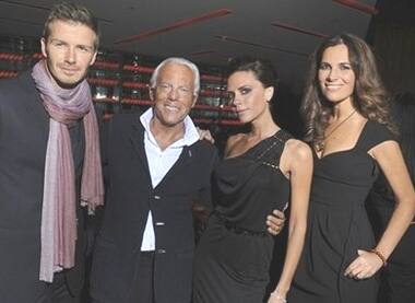 Posh Fashion: David Beckham and wife Victoria flank Giorgio Armani and nephew Roberta at the end of the Emporio Armani men's fashion collection.