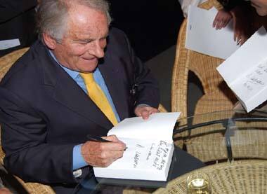 Dominique Lapierre signs the copies of his book ' Freedom At Midnight'.