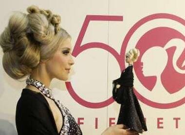 A model with 'Barbie' doll turning 50 during the 60th International Toy Fair in Nuremberg.