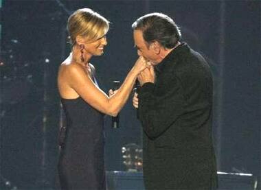 Neil Diamond kisses the hand of Faith Hill at the conclusion of their performance.