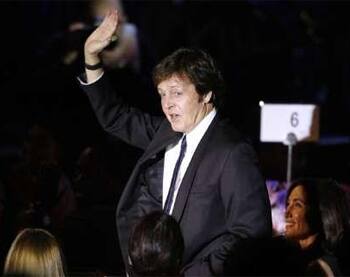 Paul McCartney waves at the 2009 Grammy Salute to Industry Icons event, honoring Clive.