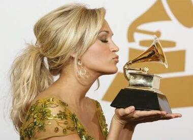 Carrie Underwood poses with her Best Female Country Vocal Performance award for 'Last Name' at Grammy Awards in LA.