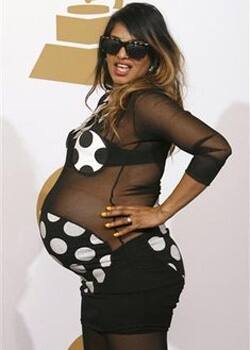 Pregnant MIA poses backstage after performing at the Grammy Awards in Los Angeles.