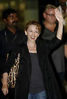 Australian singer Kylie Minogue sits in a car after arriving at the international airport in Mumbai early February 26, 2009. Minogue is in Mumbai to work on a music video for the Bollywood film 'Blue'