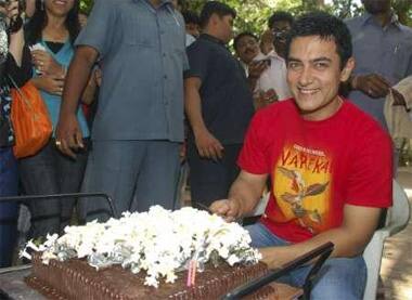 Birthday baby grins: Aamir Khan cuts the cake in Mumbia. He turns 44.