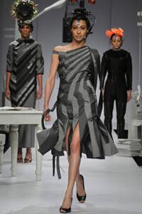 In Nitin Bal Chauhan's ensemble, colour erupts in headgear, contrasting with grey-black coloured straight lined dress.