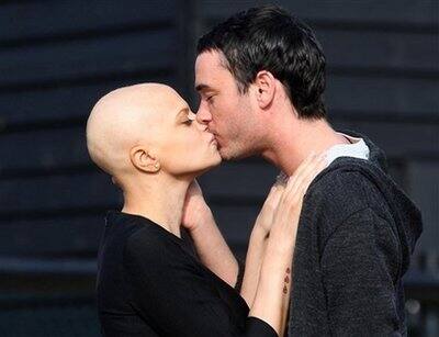 Cancer-stricken reality TV star Jade Goody and her fiance Jack Tweed, right, share a kiss on the drive way of her home in Upshire, southern England Saturday Feb. 21, 2009. The couple are scheduled to 