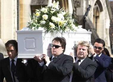 Jade Goody's husband (right) carries her coffin in the last journey.