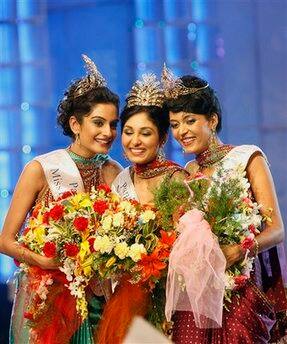 Winners of the Femina Miss India 2009 contest seen, from left, Miss Universe Ekta Chaudhary, Miss World Pooja Chopra and Miss Earth Shriya Kishore, gesture after being declared winners in Mumbai, Indi