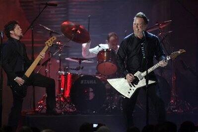 Former band member Jason Newsted, left, joins as James Hetfield, right, of Metallica perform after the band was inducted into the Rock and Roll Hall of Fame at the 2009 Rock and Roll Hall of Fame Indu