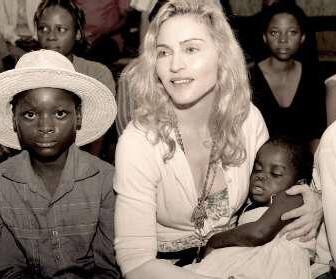 Madonna holds the child named Mercy, whom she hopes to adopt, in Malawi.